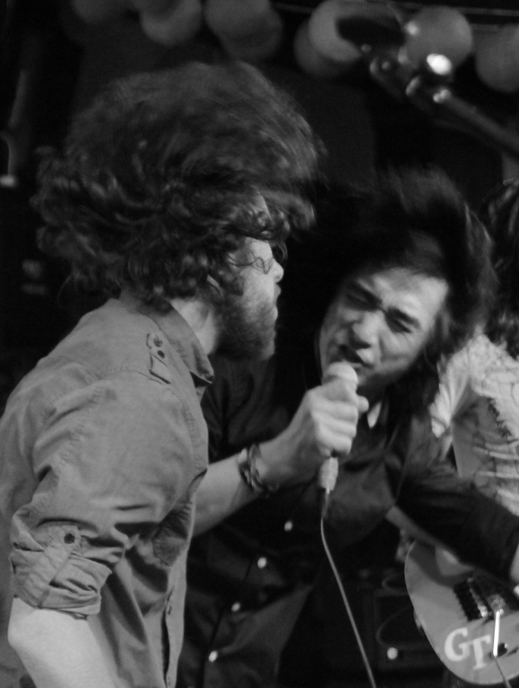 Ding Wu rocking out with an enthused dude on stage