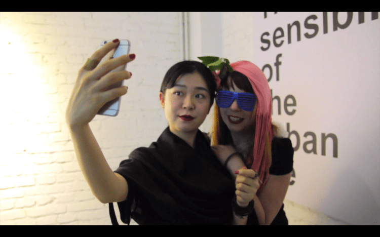 Still of Erica and a fan in Chengdu from the upcoming Orchestra of Spheres: Te China Rockumentary series presented by Kiwese in early May.